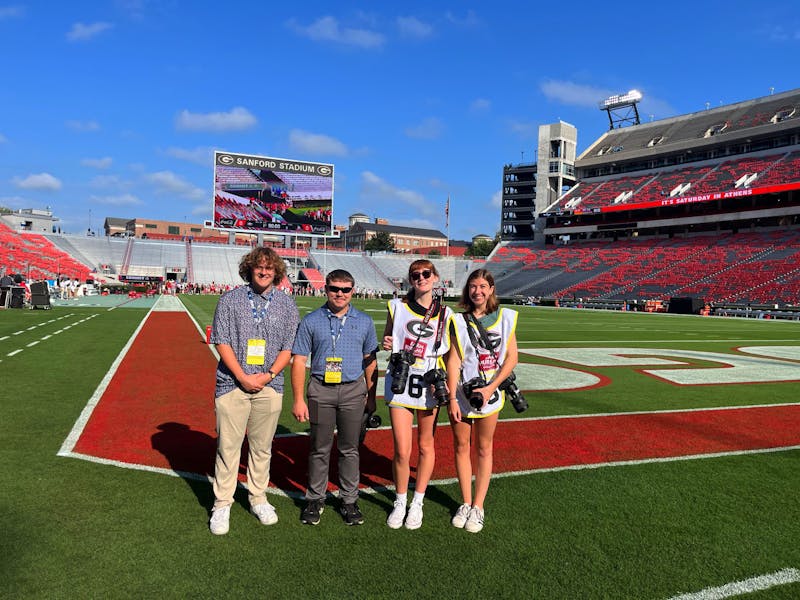 Ball State Daily News associate sports editor Elijah Poe,  reporter Zach Carter, opinion editor Kate Farr, and associate photo editor Mya Cataline pose for photo on the field at Sanford Stadium Sept. 9 in Athens, Ga. Photo provided
