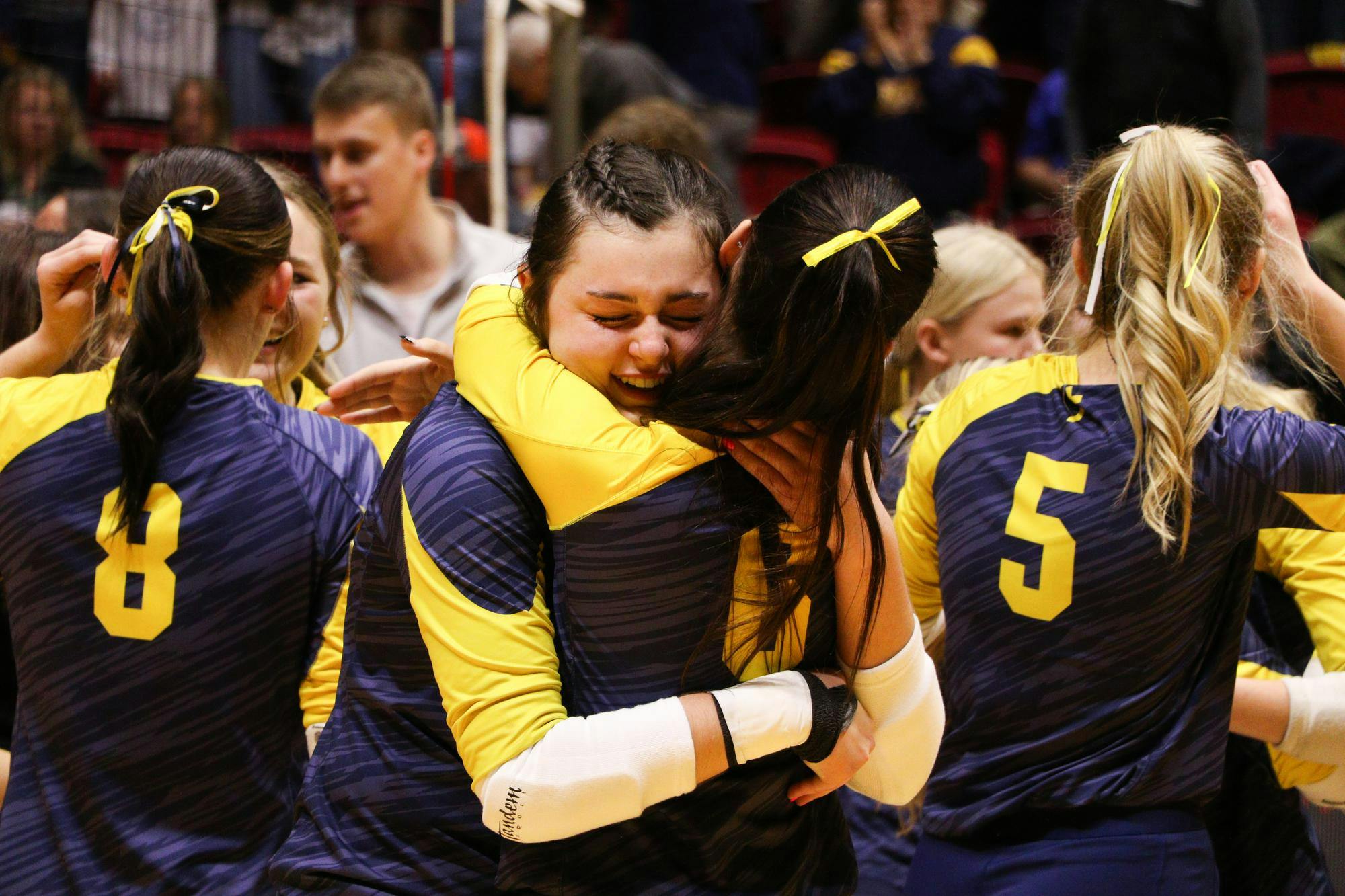 Two Trinity Lutheran volleyball players hug Nov. 9 after winning the IHSAA 1A State Championship title at Worthen Arena. It's the first state title in any sport for the school. Zach Carter, DN