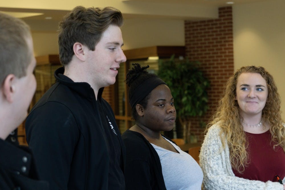 Senators Marcus Jennings, Justin Plowdrey, Lilly Owsley and Emily Lahey listen to students at the Atrium Oct. 16 during SGA’s “blitz” event, during which senators talk to students to assess their needs. Some of the more popular student issues were parking, the Health Center’s services and bus loop additions or changes. John Lynch, DN.