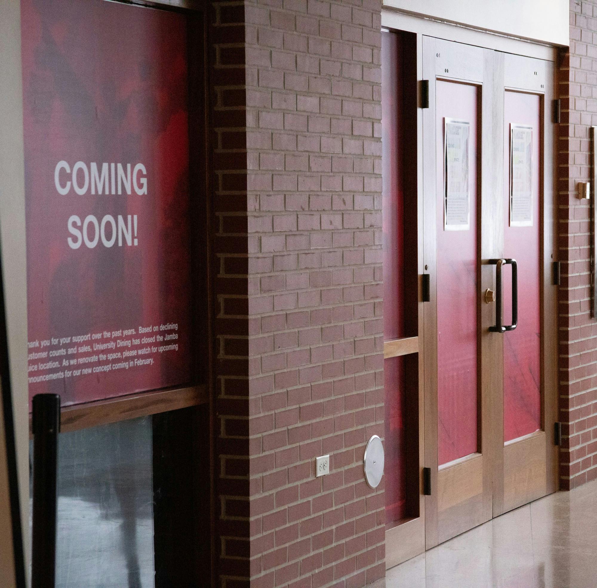 A “Coming Soon” window sign sticks to the window outside of the former Jamba Juice entrance Feb. 8, 2021, in the Atrium. The new cafe and convenience store is expected to open Feb. 15. Grace Walton, DN