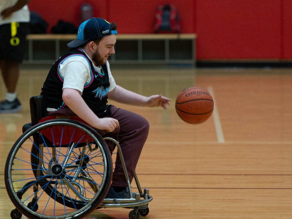 Aaron Gillen, junior exchange student, smiles as he moves the ball upcourt March 27, 2019 in the Student Receration and Wellness Center. The group is attempting to make wheelchair basketball into a club sport. Scott Fleener, DN