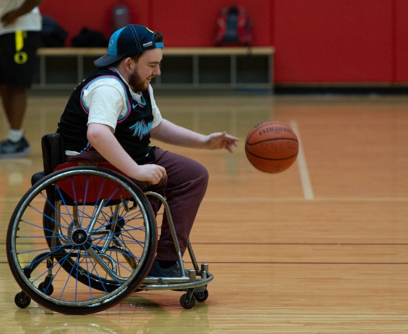 Aaron Gillen, junior exchange student, smiles as he moves the ball upcourt March 27, 2019 in the Student Receration and Wellness Center. The group is attempting to make wheelchair basketball into a club sport. Scott Fleener, DN