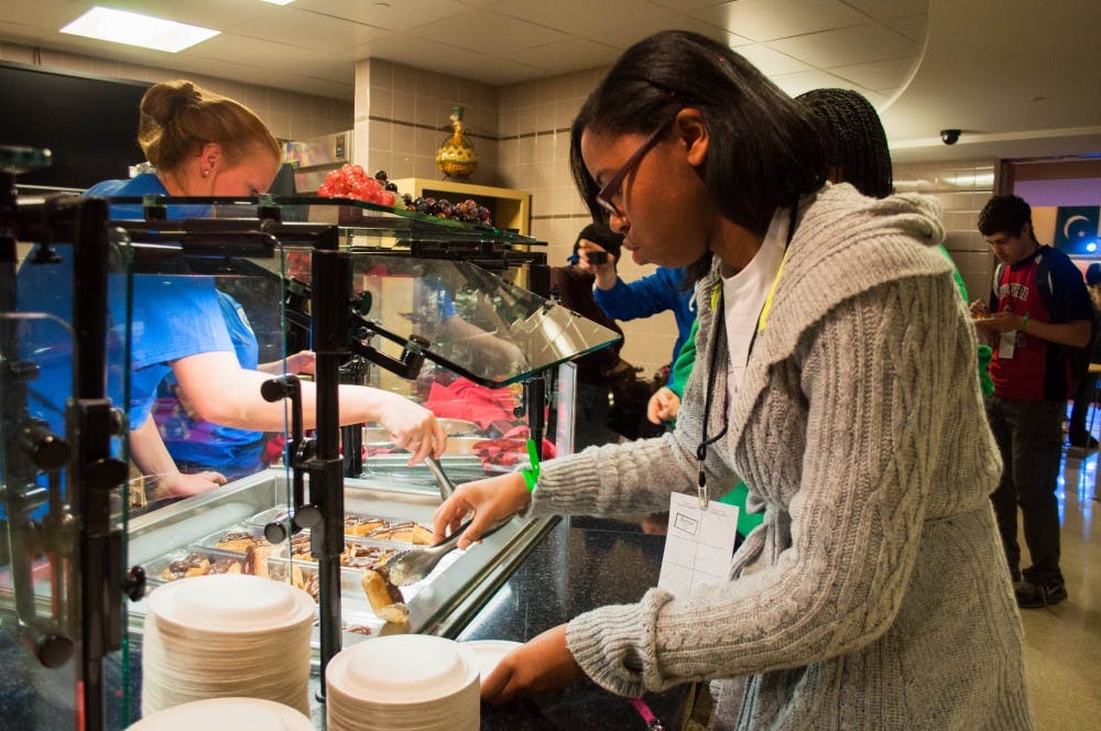 Valerie McGair gets some food at the Amazing Taste in the L.A. Pittenger Student Center on Thursday. Attendees to the event were able to eat food from around the world in the cafeteria and attend activities in the food court of the student center. DN PHOTO KATIE GRAY