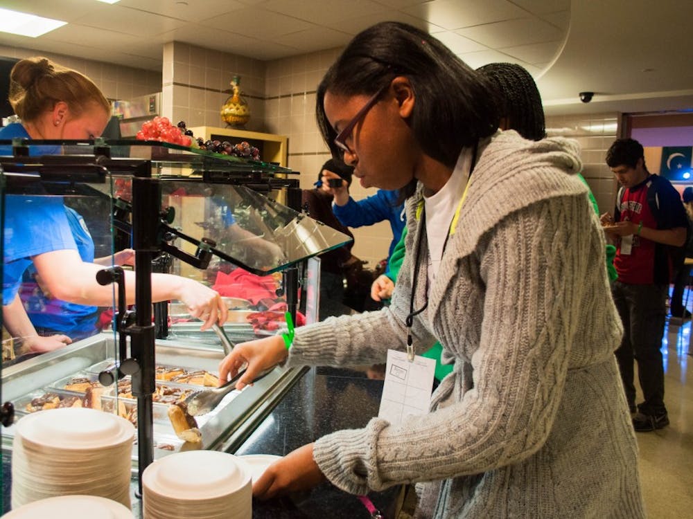 Valerie McGair gets some food at the Amazing Taste in the L.A. Pittenger Student Center on Thursday. Attendees to the event were able to eat food from around the world in the cafeteria and attend activities in the food court of the student center. DN PHOTO KATIE GRAY