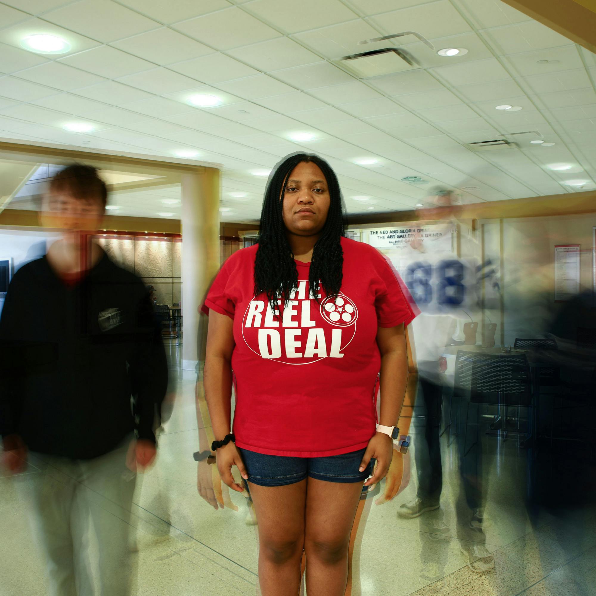 Third-year theatre creation major Keeona Stewart poses for a portrait March 29 in the Atrium. Jacy Bradley, DN Photo; Alex Bracken, DN Photo Illustration