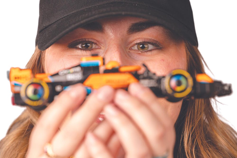 Ball State junior Madelyn Bracken poses for a photo with a miniature racecar Jan. 8 at the Art and Journalism Building. Bracken runs a popular TikTok account where she discusses her love of the sport. Titus Slaughter, DN 