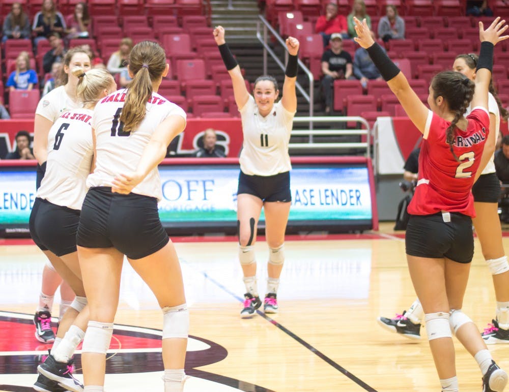 Ball State's women's volleyball team celebrate after scoring against Western Michigan on Oct. 6 in John E. Worhen Arena. The Cardinals won 3-1. Terence K. Lightning Jr., DN