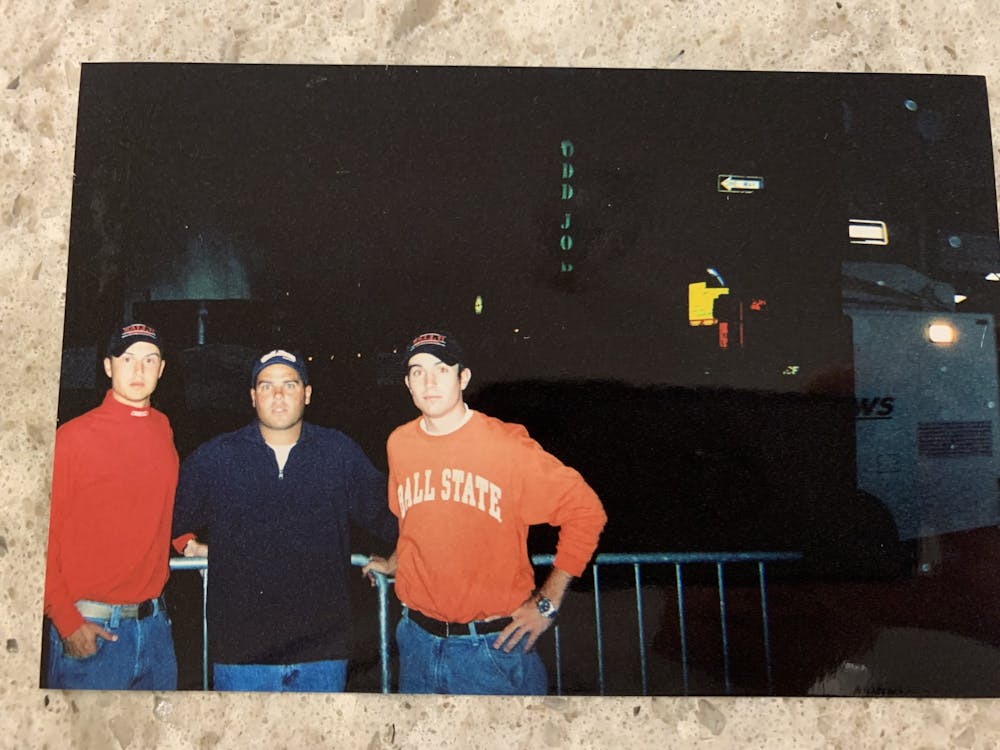 Nathan Vannatter (left), Mike Fleck (middle) and Lance Scholl (right) stand next to a police car near the site of where two planes crashed into the World Trade Center Sept. 11, 2001. Nathan Vannatter, provided. 