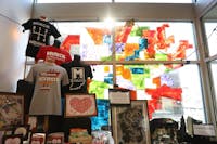 Sun shines through a mural on the front window of Muncie Map Co. Jan. 25 in downtown Muncie. Owner Andy Shears started the company by selling maps out of the trunk of his car. Rylan Capper, DN 
