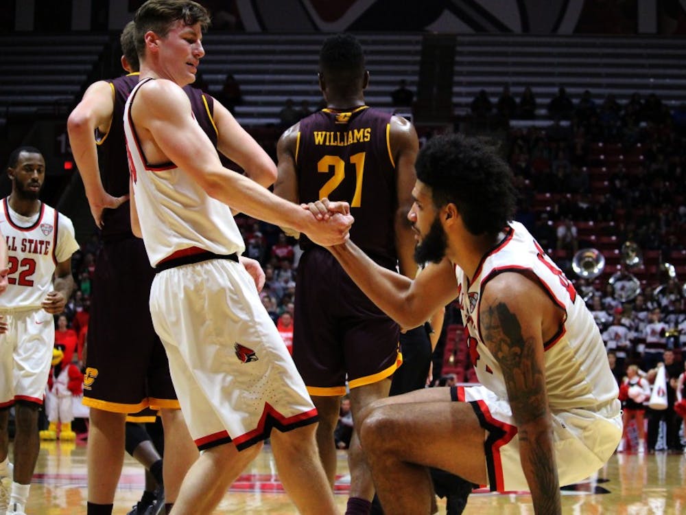 Ryan Weber helps teammate Trey Moses up after a fall in the game against Central Michigan in Worthen Arena on Jan. 17. Alicia M. Barnachea // DN. 