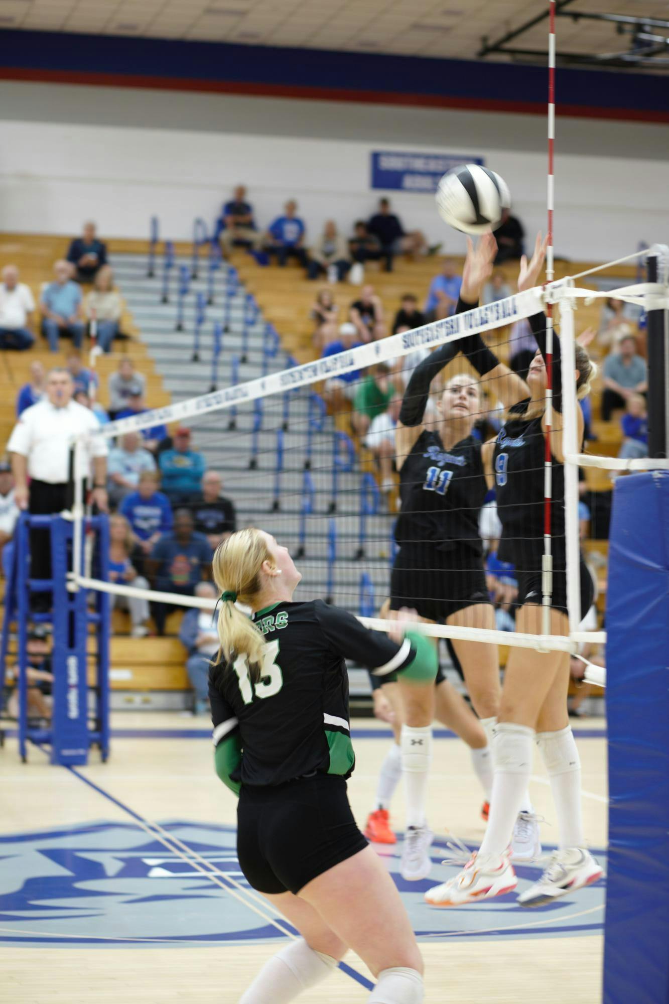 Tigers’ Liv Jones, No. 13, readies to block a return from the Royals. The Royals’ front liners Raegan Miles, No. 11, and Madi Miles, No. 9, proved to be a constant threat throughout the match. PHOTO BY ASHTON CONNELLY
