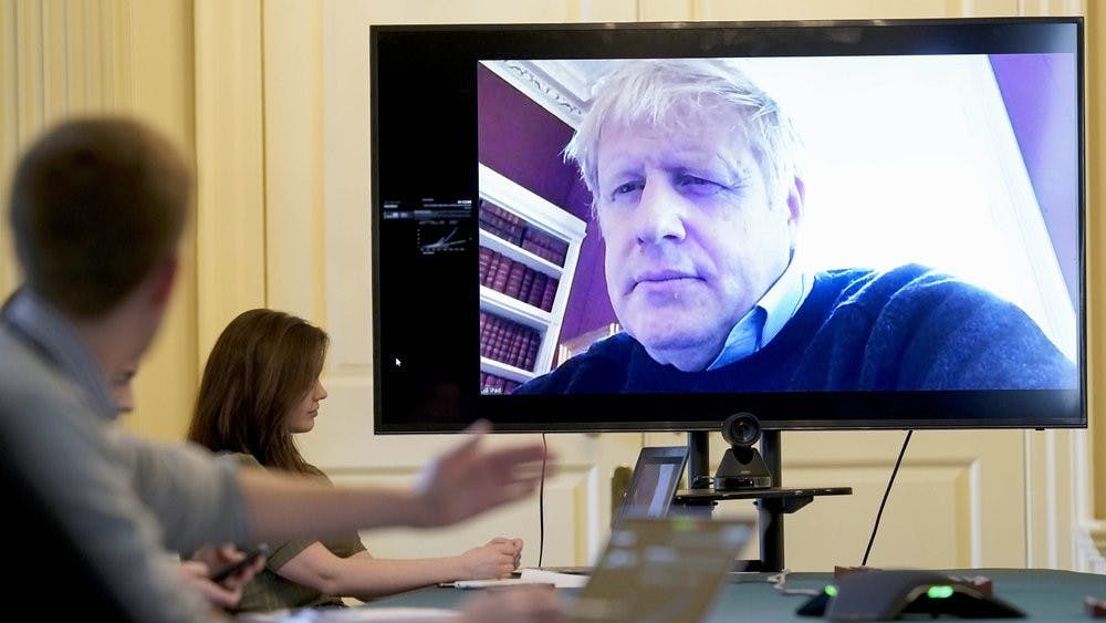 In this Saturday, March 28, 2020 handout photo provided by Number 10 Downing Street, Britain's Prime Minister Boris Johnson chairs the morning Covid-19 Meeting remotely after self isolating after testing positive for the coronavirus, at 10 Downing Street, London. British Prime Minister Boris Johnson has been admitted to a hospital with the coronavirus. Johnson’s office says he is being admitted for tests because he still has symptoms 10 days after testing positive for the virus. (Andrew Parsons/10 Downing Street via AP, File)