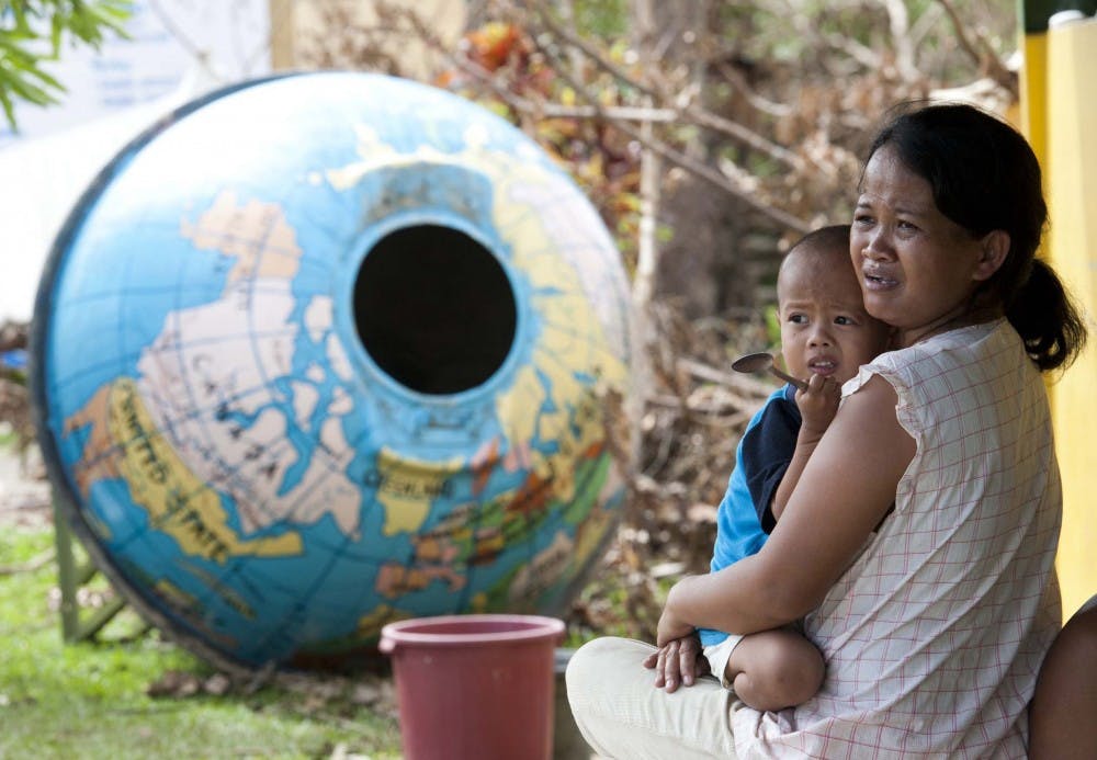 A mother and her young child seek refuge in a damaged school in a neighbourhood in Tacloban city, Leyte province, central Philippines in search of help on Nov. 13. Survivors of Typhoon Haiyan in the Philippines are increasingly desperate for food, water and medical supplies, officials in affected areas say. The official death toll stands at more than 2,000, though some reports say it could be as high as 10,000. The UN said more than 11 million people may have been affected and some 673,000 displaced. On Tuesday, eight people died when a wall collapsed as thousands of survivors mobbed a food warehouse. MCT PHOTO