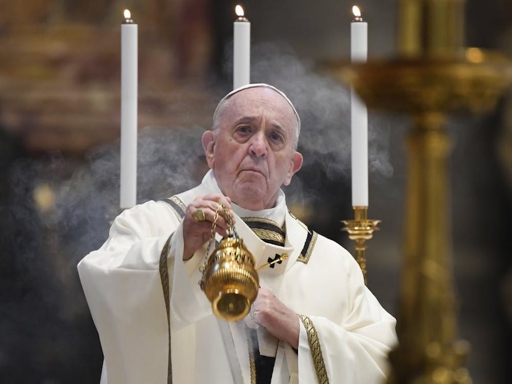 Pope Francis spreads incense at the start of Easter Sunday Mass, inside an empty St. Peter's Basilica at the Vatican, Sunday, April 12, 2020. Pope Francis and Christians around the world marked a solitary Easter Sunday, forced to celebrate the most joyful day in the liturgical calendar amid the sorrowful reminders of the devastation wrought by the coronavirus pandemic. The new coronavirus causes mild or moderate symptoms for most people, but for some, especially older adults and people with existing health problems, it can cause more severe illness or death. Andreas Solaro/Pool via AP