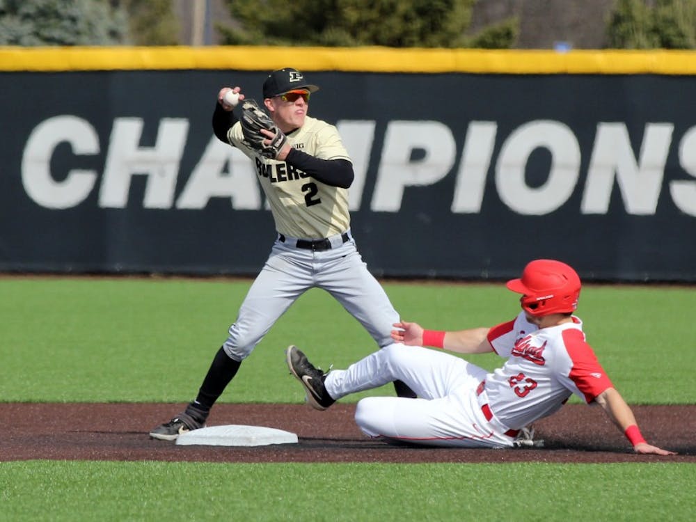 Purdue second baseman Tyler Powers throws the ball to first as Ball State junior Ross Messina slides into second for a double play in the third inning of the Cardinals game against the Boilermakers March 19 at Ball Diamond at First Merchant's Ballpark Complex. Ball State won 6-0. Paige Grider, DN