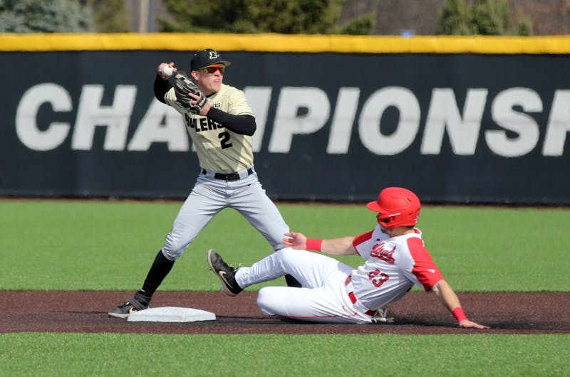 Purdue second baseman Tyler Powers throws the ball to first as Ball State junior Ross Messina slides into second for a double play in the third inning of the Cardinals game against the Boilermakers March 19 at Ball Diamond at First Merchant's Ballpark Complex. Ball State won 6-0. Paige Grider, DN