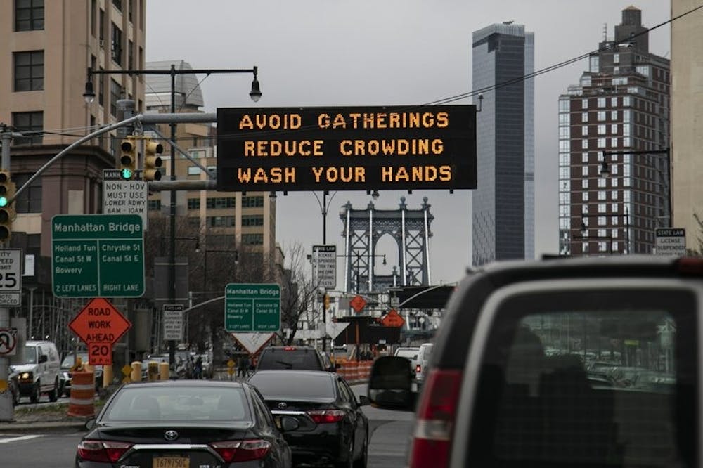 <p>In this March 19, 2020, file photo, the Manhattan bridge is seen in the background of a flashing sign urging commuters to avoid gatherings, reduce crowding and to wash hands in the Brooklyn borough of New York. The coronavirus pandemic is leading to information overload for many people, often making it difficult to separate fact from fiction and rumor from deliberate efforts to mislead. <strong>(AP Photo/Wong Maye-E, File)</strong></p>