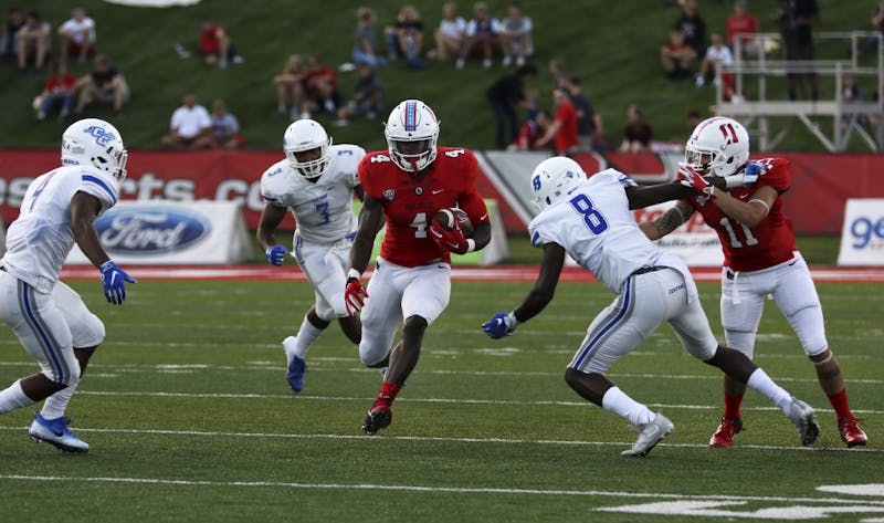 Then-junior running back Malik Dunner runs past Central Connecticut State players during Ball State's game against the Blue Devils Aug. 31, 2018, at Scheumann Stadium. Dunner had 51 rushing yards in the game. Paige Grider, DN