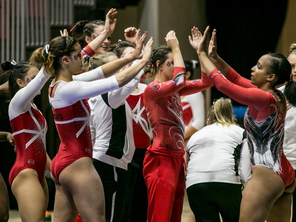Senior Jordan Penny is congratulated by her teammates after competing on the balance beam during the Red vs. White Intersquad meet on Dec. 4 in John E. Worthen Arena. Penny earned a career high 9.850 on beam at Mid-American Conference. Kaiti Sullivan, DN