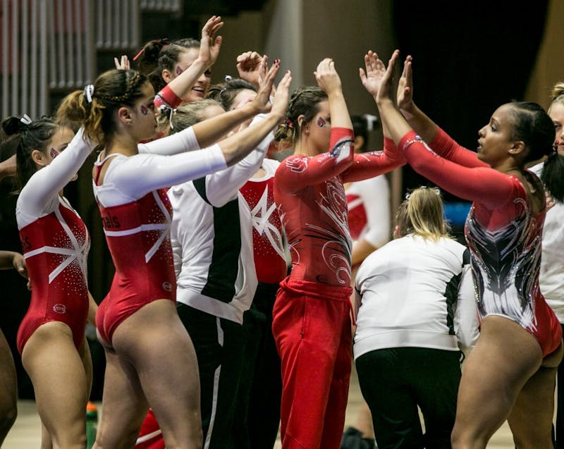 Senior Jordan Penny is congratulated by her teammates after competing on the balance beam during the Red vs. White Intersquad meet on Dec. 4 in John E. Worthen Arena. Penny earned a career high 9.850 on beam at Mid-American Conference. Kaiti Sullivan, DN