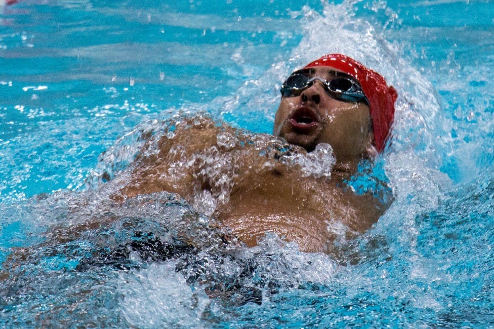 Sophomore Chase Jackson competes the 200-yard backstroke during the meet against Miami Feb. 10 at Lewellen Pool. The team has an all-time record of 341-245-3. Eric Pritchett, DN