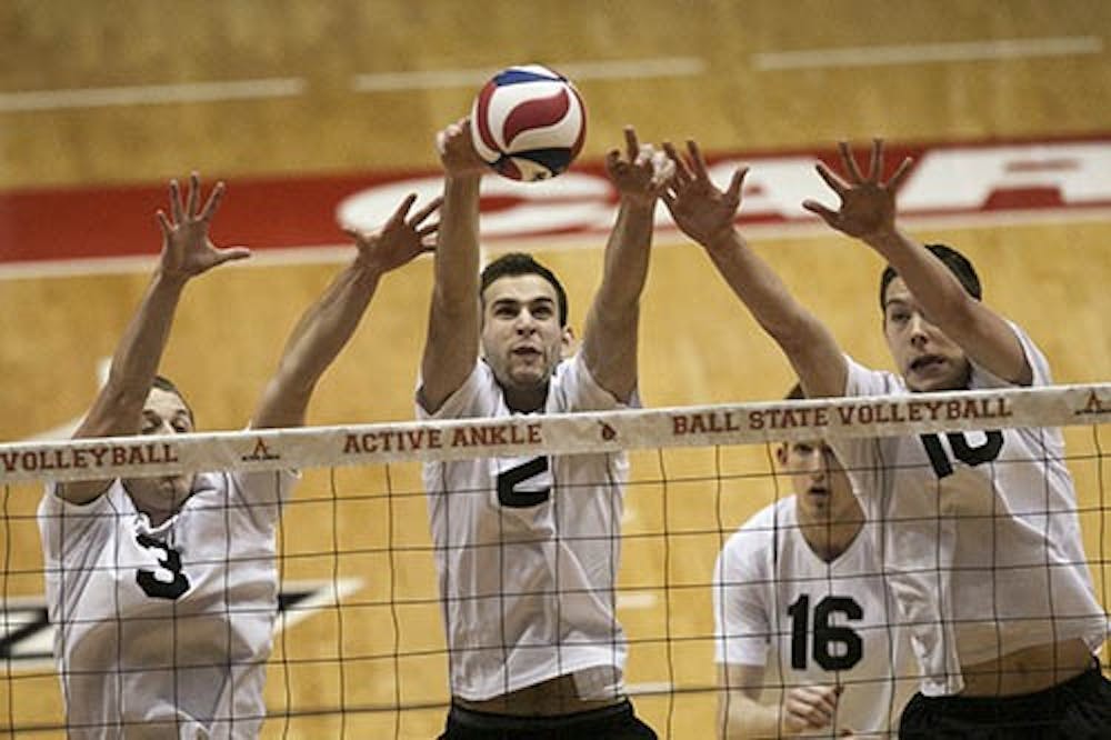Members of the men's volleyball team do their best to fight off an incoming ball in their game against Lindenwood on Feb. 2, 2013 in Worthen Arena. DN PHOTO JORDAN HUFFER