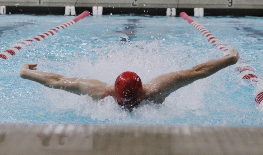 During the Doug Coers Invitational on Nov. 23, senior Drew Tharp gets a good jump to gain the lead in the 100-meter fly. DN PHOTO BRITTANY OVERSTREET