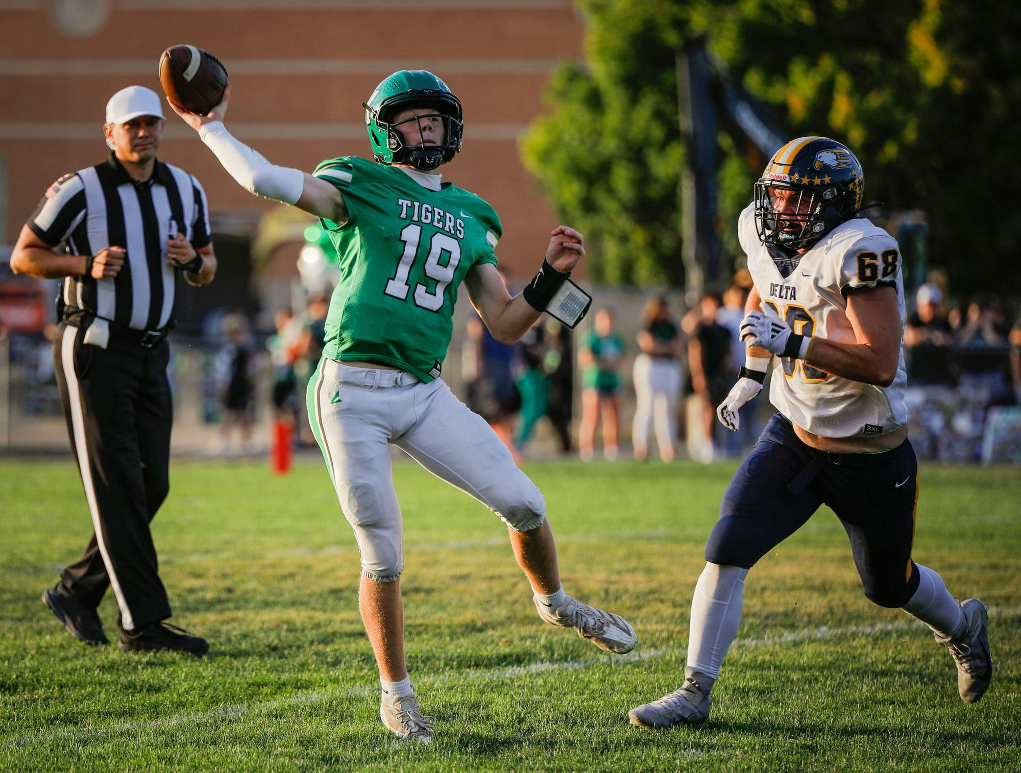 Sophomore quarterback Sam Tokar makes a last-second throw against Delta High School on Sept. 13 at Yorktown High School. Andrew Berger, DN 