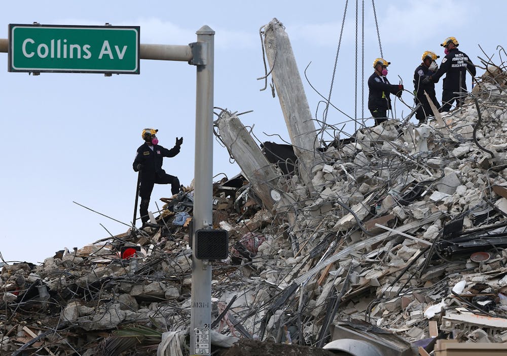 Search and rescue operations resume as members of the Pennsylvania Search and Rescue team comb through the debris several after hours after the Champlain Tower South complex was demolish on Monday, July 5, 2021 in Surfside, Florida. (Carl Juste/Miami Herald/TNS)