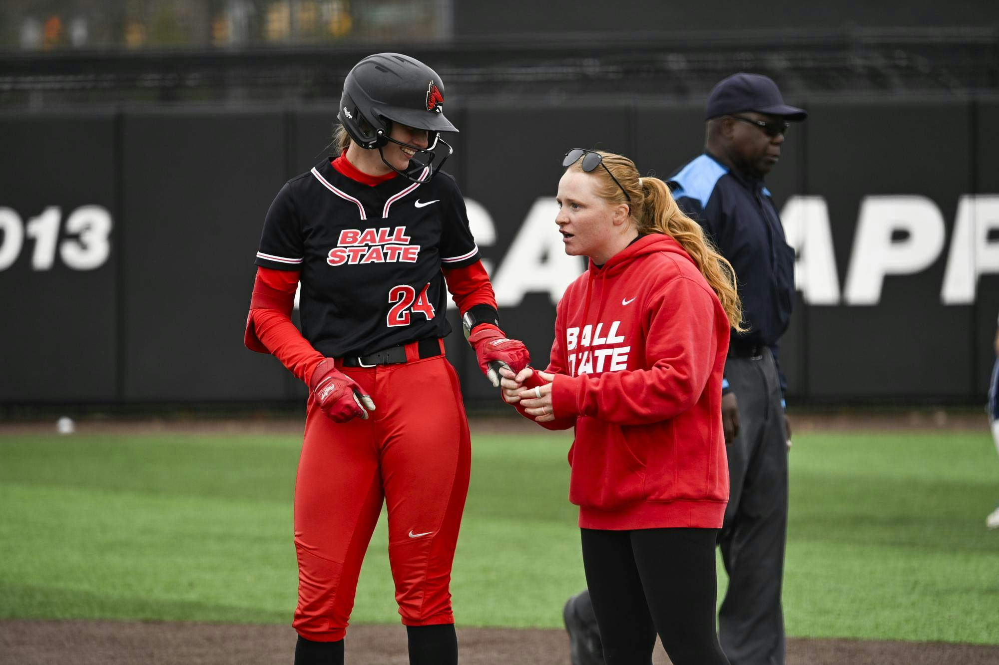 Ball State senior pitcher Jessic Hoffman chats with Ball State assistant coach Avrey Steiner at first base March 24 at Ball State Softball Stadium. Dylan Chesnut, DN