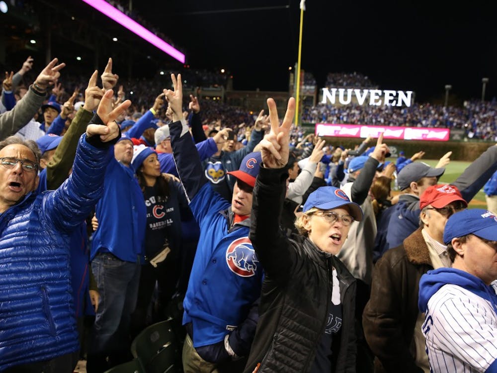 Fans sing and raise victory signs during the seventh-inning stretch during Game 6 of the National League Championship Series at Wrigley Field in Chicago on Saturday, Oct. 22, 2016. (Nuccio DiNuzzo/Chicago Tribune/TNS)