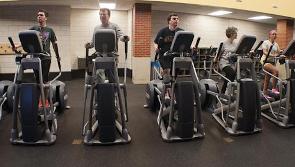 Patrons of the Student Recreation and Wellness Center work out on ellipticals Monday evening. The new year has brought more people attempting to get in better shape for New Year’s resolutions. DN PHOTO BOBBY ELLIS