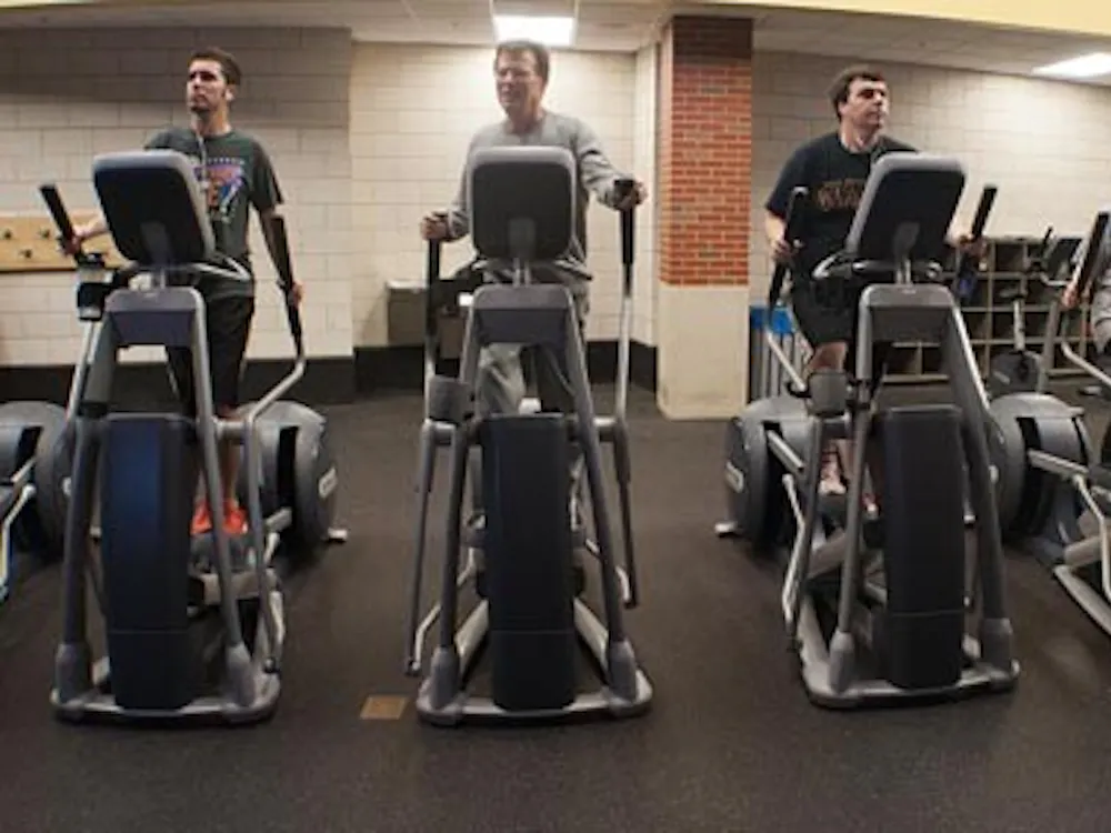 Patrons of the Student Recreation and Wellness Center work out on ellipticals Monday evening. The new year has brought more people attempting to get in better shape for New Year’s resolutions. DN PHOTO BOBBY ELLIS