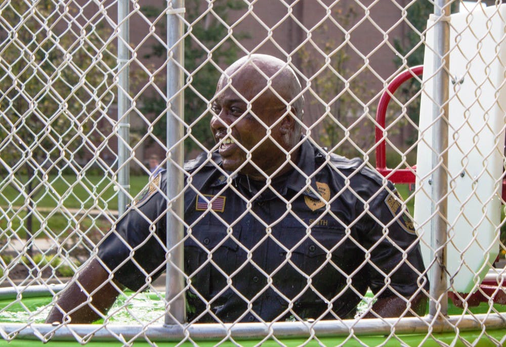 Lt. Terrell Smith of the Ball State University Police Department gets dunked by a student during Dunk-a-Cop on Aug. 25 at the Scramble Light. All proceeds will go to Riley Hospital. Grace Ramey // DN 