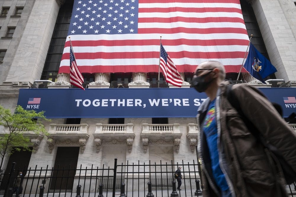 <p>A man wearing a protective face mask passes the New York Stock Exchange, May 26, 2020, as employees arrive for the partial reopening of the trading floor. <strong>(AP Photo/Mark Lennihan)</strong></p>
