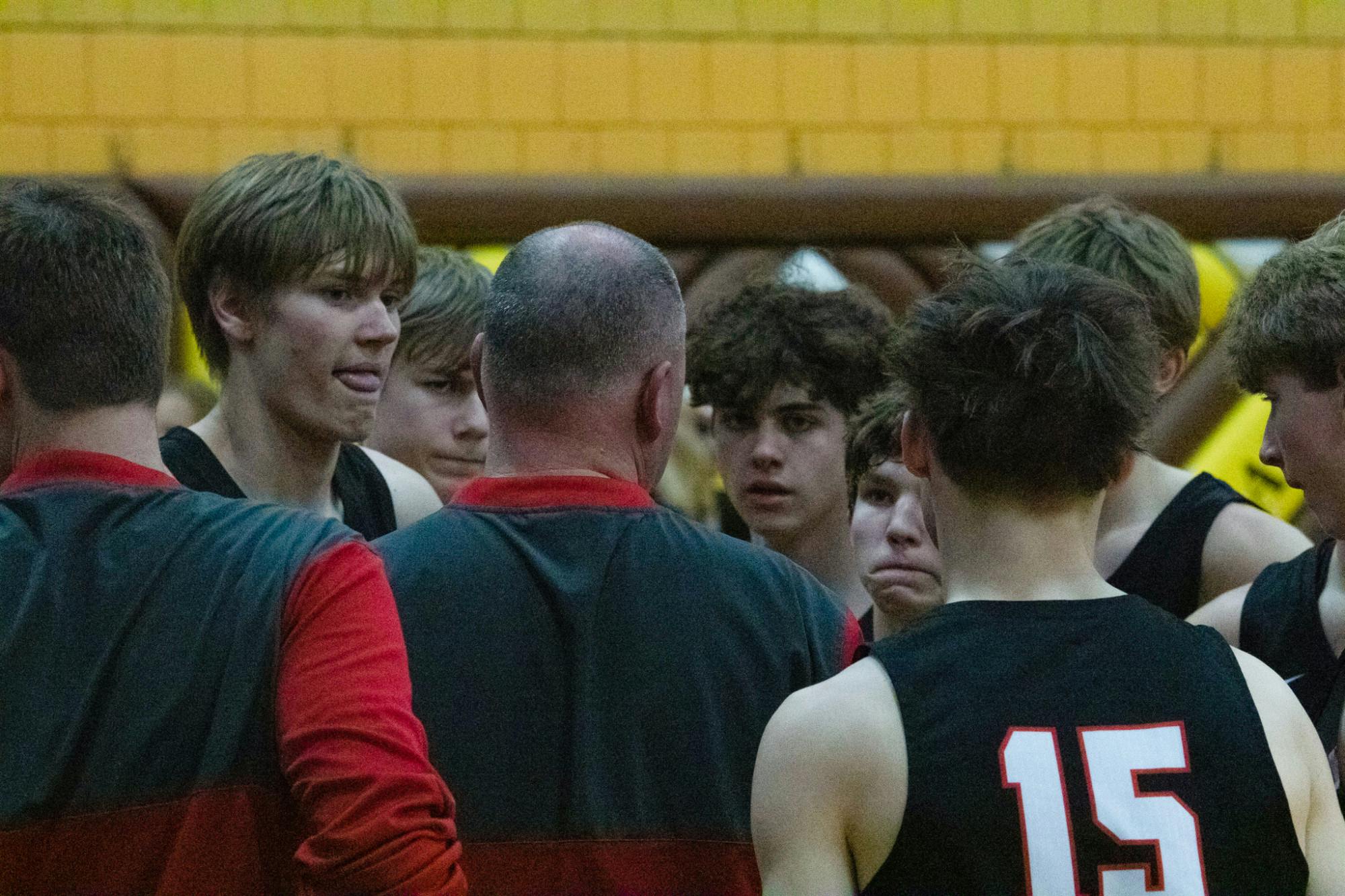 Wapahani players listen to head coach Matt Luce during a timeout in the first round of sectionals March 1 at Monroe Central High School. Zach Carter, DN