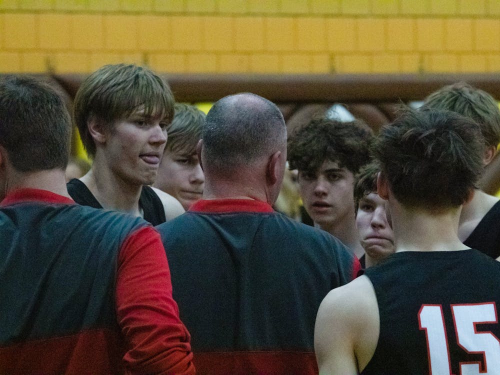 Wapahani players listen to head coach Matt Luce during a timeout in the first round of sectionals March 1 at Monroe Central High School. Zach Carter, DN