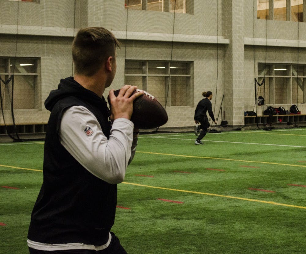 Cincinnati Bengals quarterback Keith Wenning passes to WIllie Snead, a receiver for the New Orleans Saints, in the Rec Center. They were two of several current and former Ball State players that got together for an unofficial off-season workout on Wednesday. DN PHOTO COLIN GRYLLS