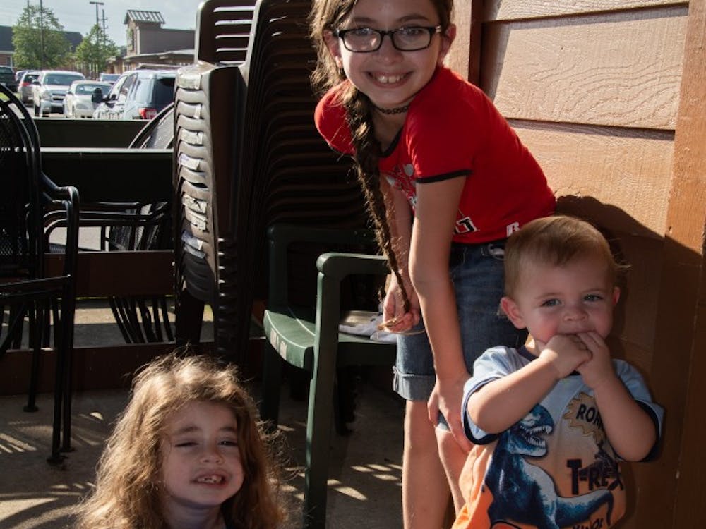 Kids play and stop for a picture at the fifth annual Battle of the Badges rib-eating contest at Texas Roadhouse Sept. 18, 2018, at Texas Roadhouse in Muncie. Ten percent of every meal bought during the competition was donated to the charity of the winner's choosing. Leslie Gartrell,DN