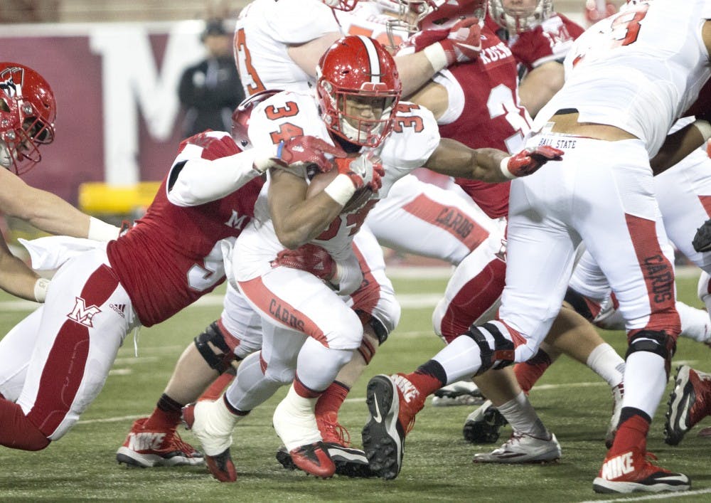 Running back, James Gilbert seeks for the end zone against the Miami Redhawks, but what brought down by linebacker Brad Earnest at Yager Stadium. Ball State lost to Miami University, 21-20. 