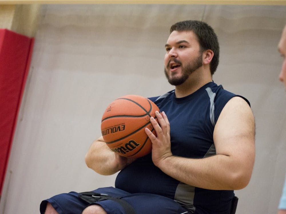 Junior chemistry and pre med major Matthew Marshall explains to the new players how to pass, dribble, and shoot while playing wheelchair basketball on Sept. 23 at the Jo Ann Gora Student Recreation and Health Center. DN PHOTO ALAINA JAYE HALSEY