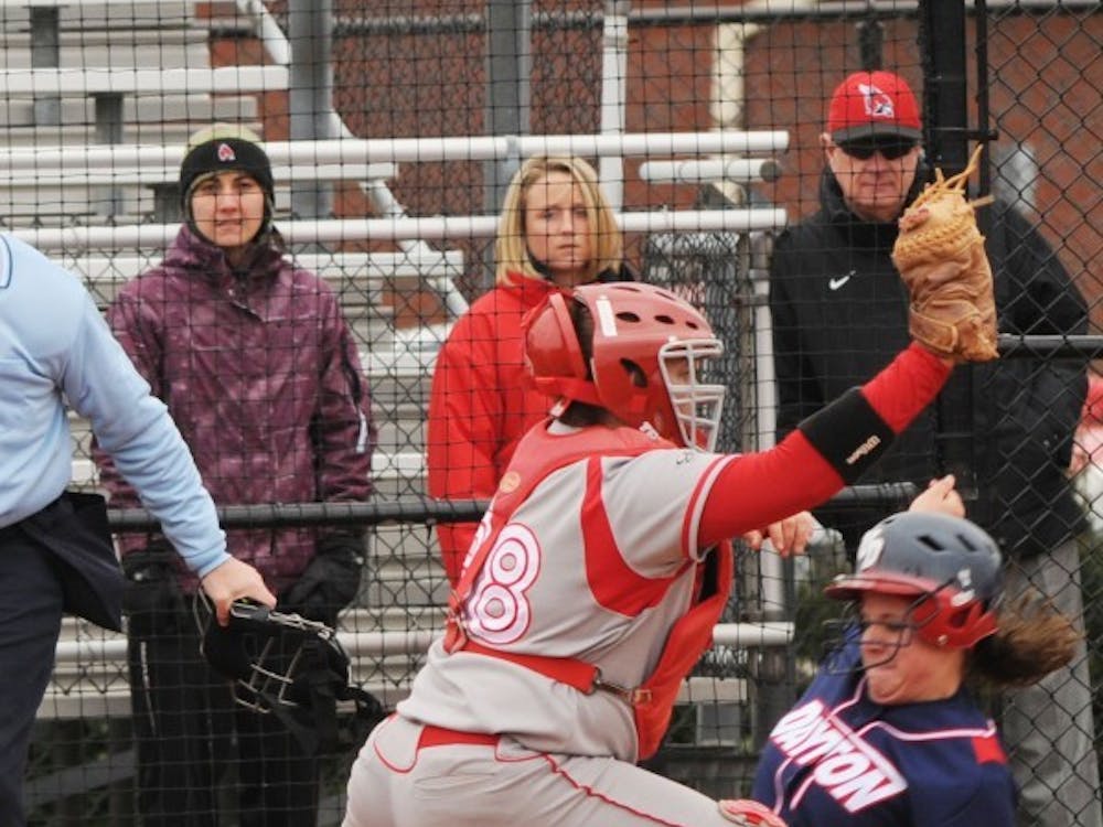 Catcher Amanda Montalto attempts to tag a Dayton player out at home earlier this season. Ball State defeated Miami Sunday 1-0. DN FILE PHOTO JESS LANNING