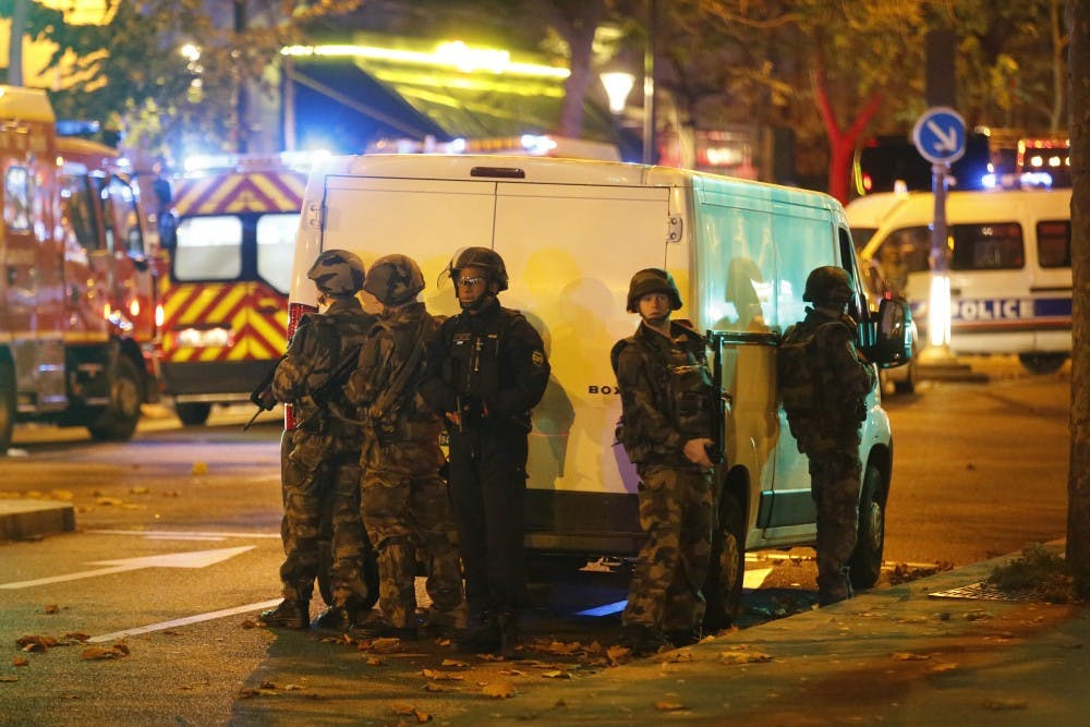 Security forces and police outside the Bataclan concert hall in central Paris as people are being held hostage on Friday, Nov. 13, 2015. After clearing the hall of attackers, officials reportedly found more than 100 dead inside. (Olivier Corsan/Maxppp/Zuma Press/TNS)