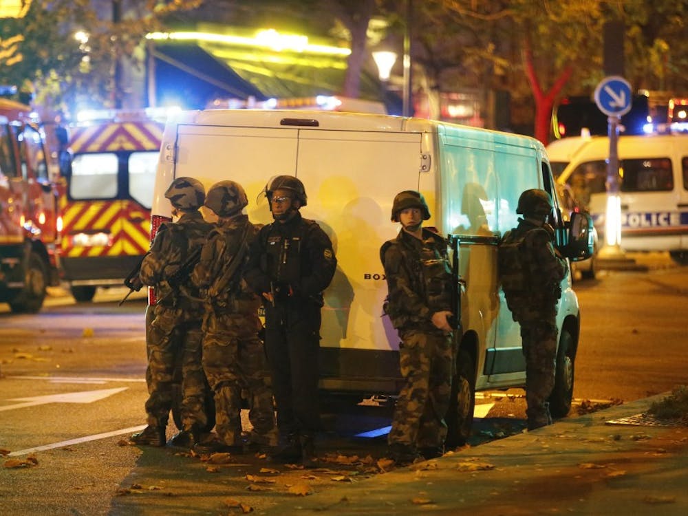 Security forces and police outside the Bataclan concert hall in central Paris as people are being held hostage on Friday, Nov. 13, 2015. After clearing the hall of attackers, officials reportedly found more than 100 dead inside. (Olivier Corsan/Maxppp/Zuma Press/TNS)