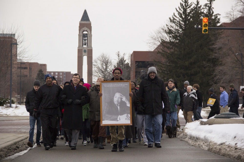 Marchers walk on McKinley Avenue for the Unity March to honor Martin Luther King Jr. Day. The march started at the Multicultural Center and turned around at the Scramble Light. DN PHOTO EMMA ROGERS