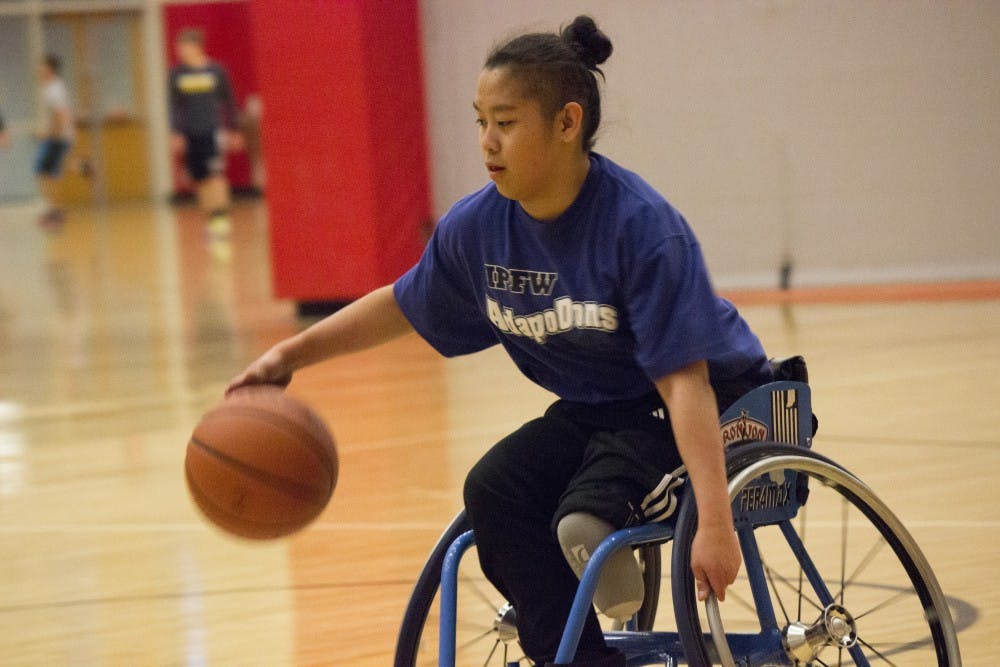 A player races down the court for a layup during a game of wheelchair basketball March 31 at the Student Recreation and Wellness Center. This scrimmage against the IPFW AdaptoDons was the team
