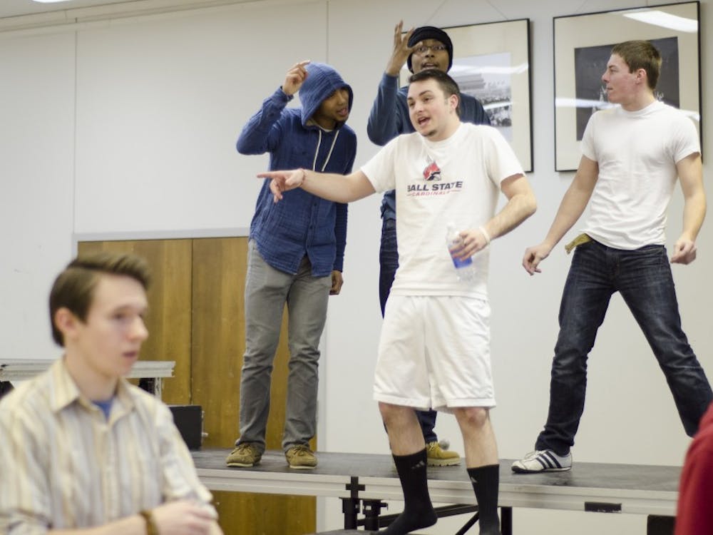 Michael Kuhn jokes around with fellow members of Note to Self before rehearsing choreography for upcoming shows this month. Members in the group say the community makes hard work worth going through. DN PHOTO COREY OHLENKAMP