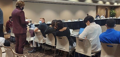 Senator Grant Wilson talks with other senators at the Student Government Association (SGA) meeting Oct. 20, 2021. Wilson wrote the amendment to establish a vice secretary position for all committees and caucuses, which failed 16-21. Nathan Hill, DN