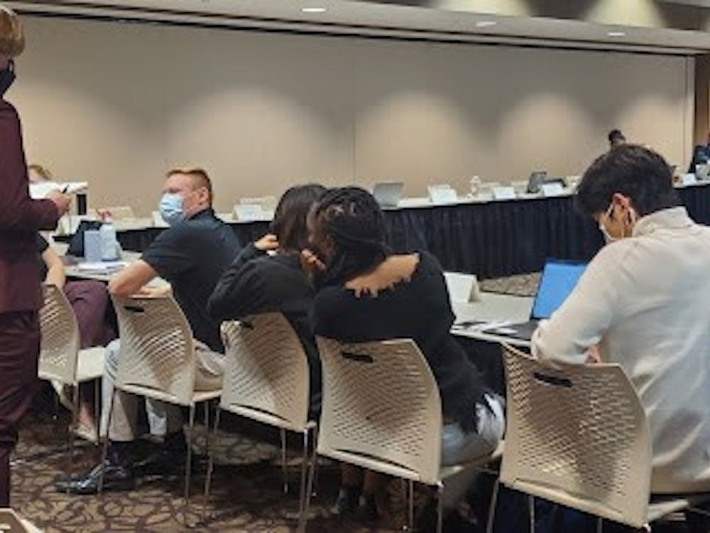 Senator Grant Wilson talks with other senators at the Student Government Association (SGA) meeting Oct. 20, 2021. Wilson wrote the amendment to establish a vice secretary position for all committees and caucuses, which failed 16-21. Nathan Hill, DN