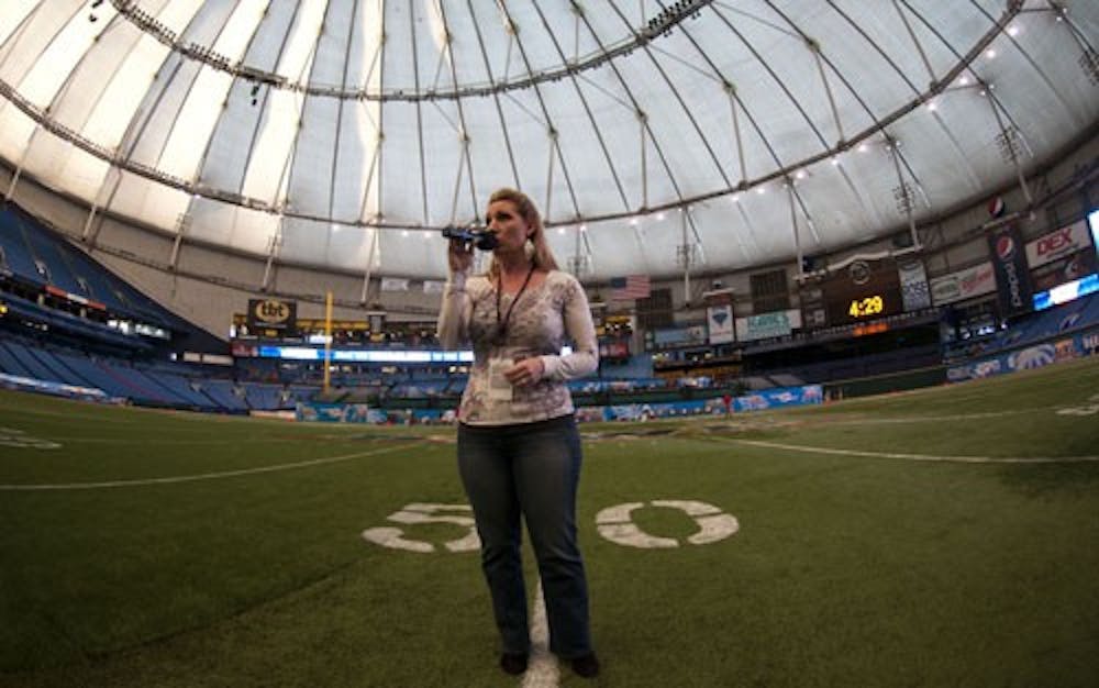 Shelly Starks practices singing the Star Bangled Banner on the 50 yard line at Tropicana Field before the Beef 'O' Brady's Bowl. This will be the first time Starks has performed the national anthem at Tropicana Field. DN PHOTO BOBBY ELLIS